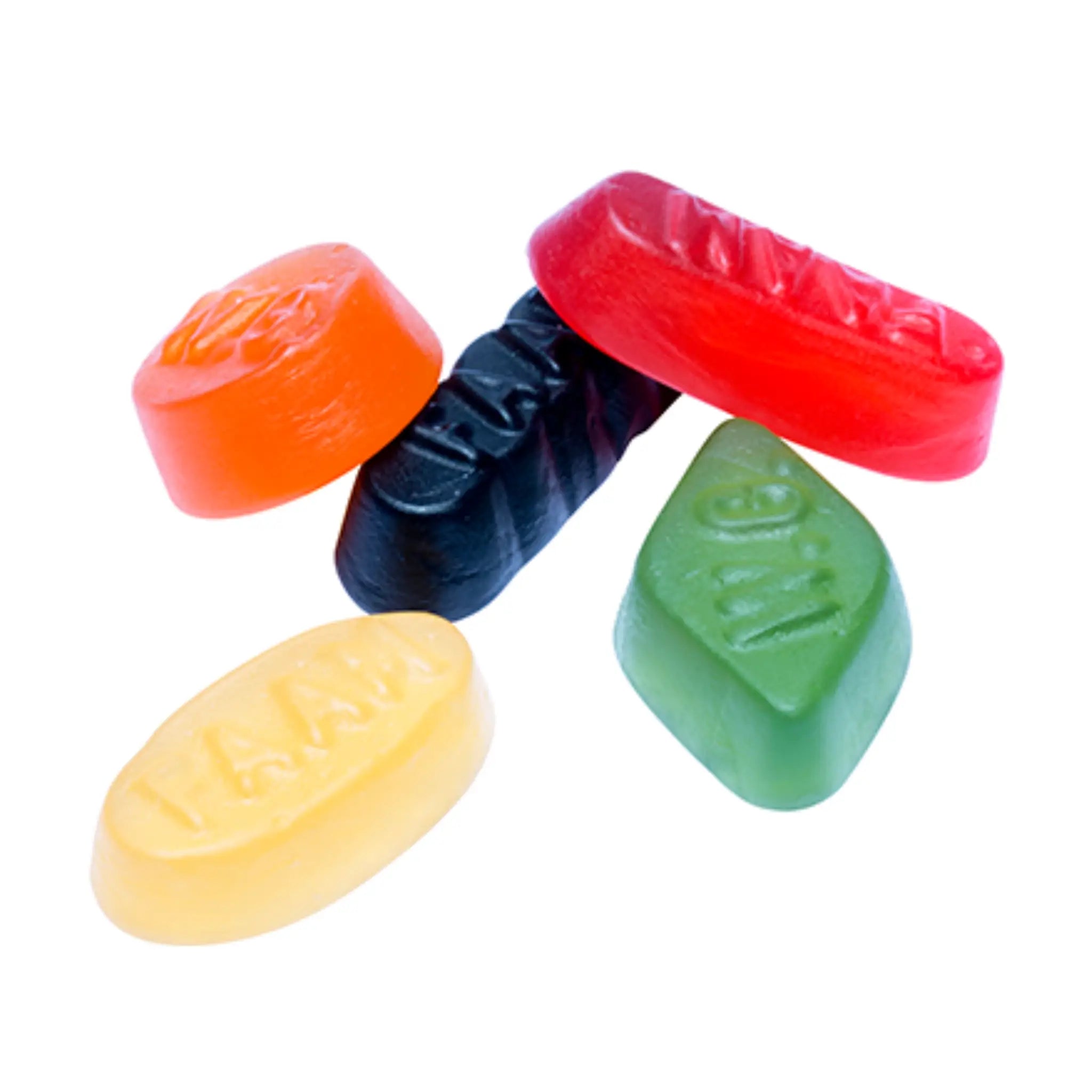 Five pieces of candy in different shapes, in orange, green, black, yellow and red.