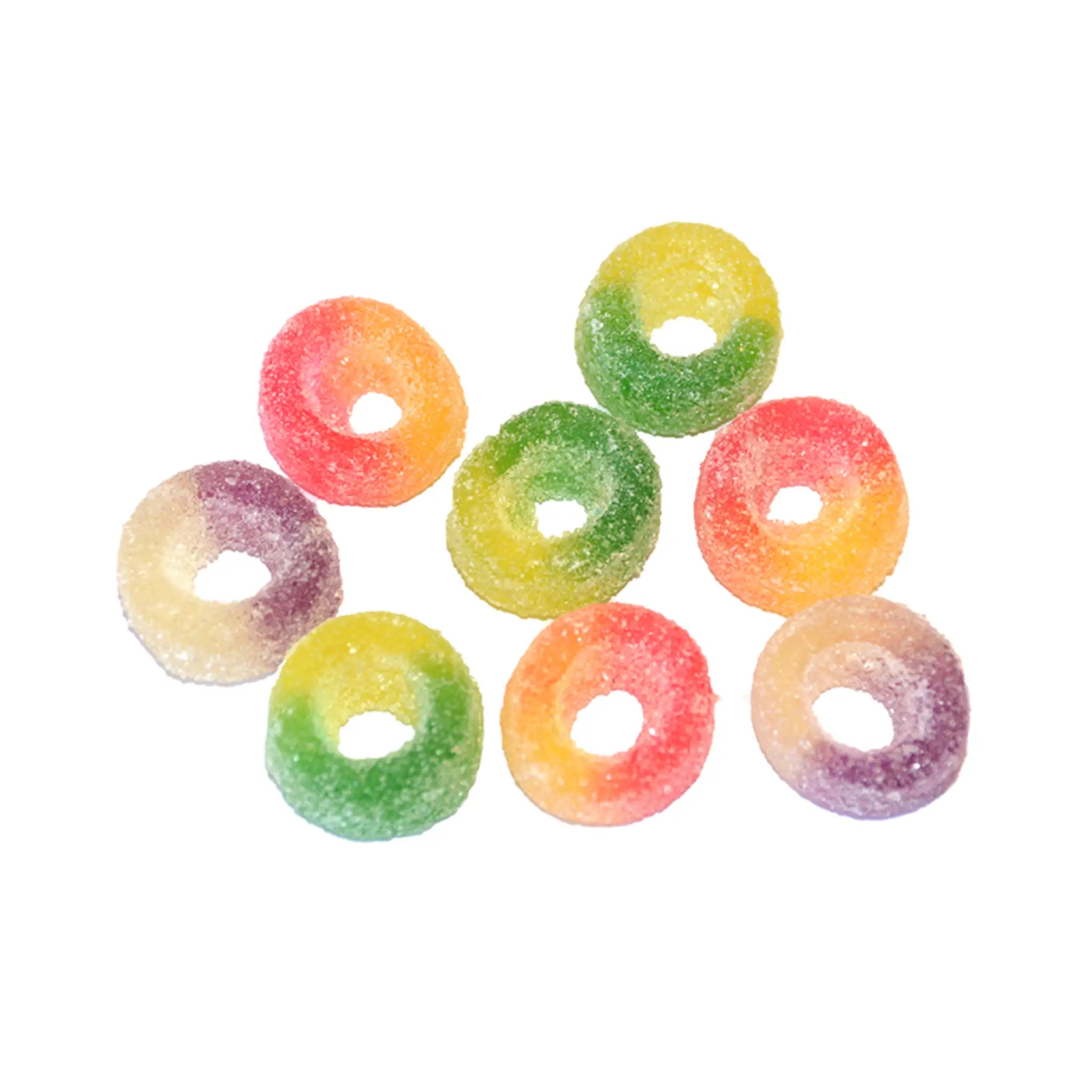 Eight pieces of Swedish candy in the shape of rings, coated in sugar, in pink and orange, purple and white, and green and yellow.