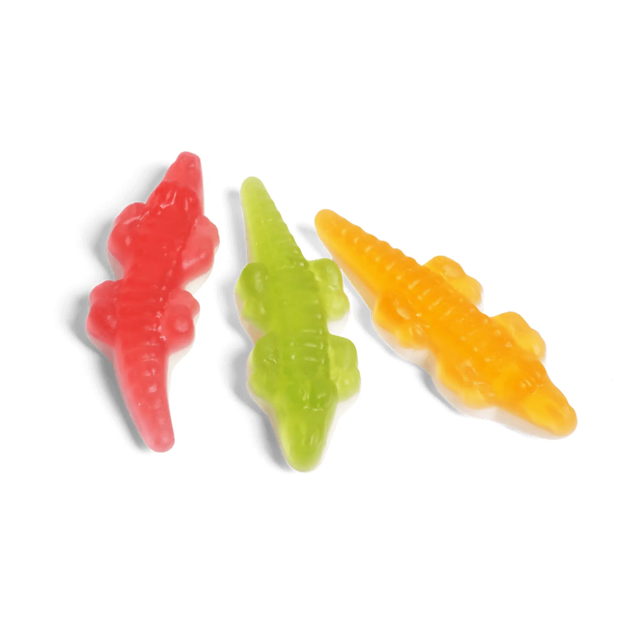 Three pieces of Swedish candy in the shape of red, blue and yellow crocodiles.