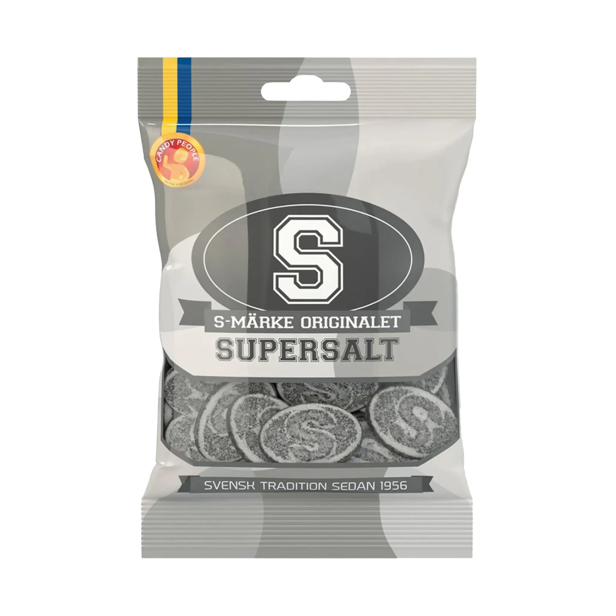 Swedish candy in black, in oval shape and with the letter "S" on the front of each one, wrapped in a bag in gray,