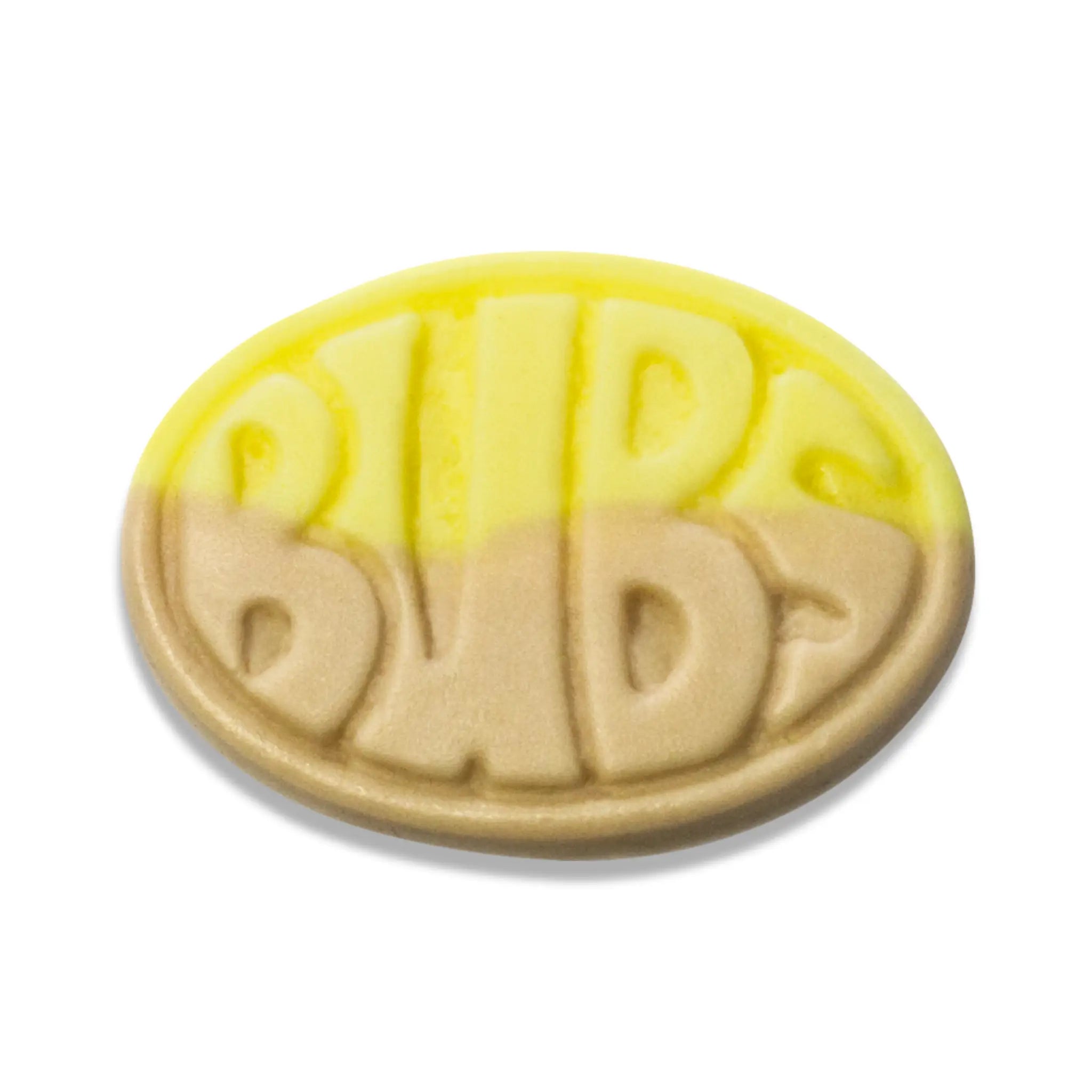 A piece of Swedish candy in the shape of an oval, in yellow and brown, with the word "Bubs" in the front.