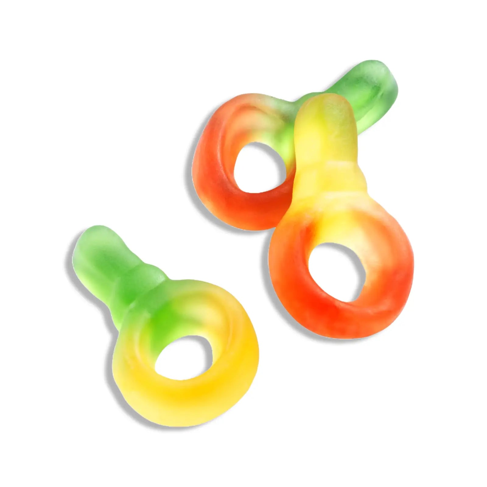Three pieces of Swedish candy in the shape of pacifiers in green and yellow, red and yellow, and green and red.
